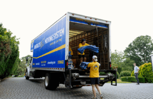 movers in greenville loading items into the back of a moving truck 